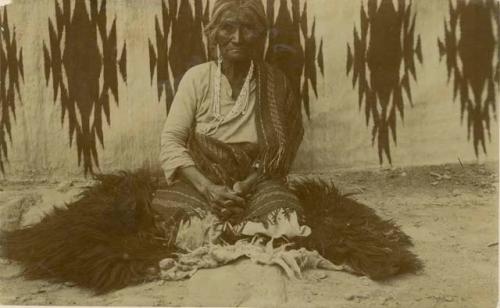 Navajo woman sitting on a sheepskin