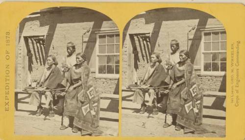 Navajo boys and woman in front of the quarters at old Fort Defiance