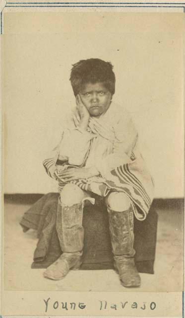 Young Navajo, seated boy about 7 years old