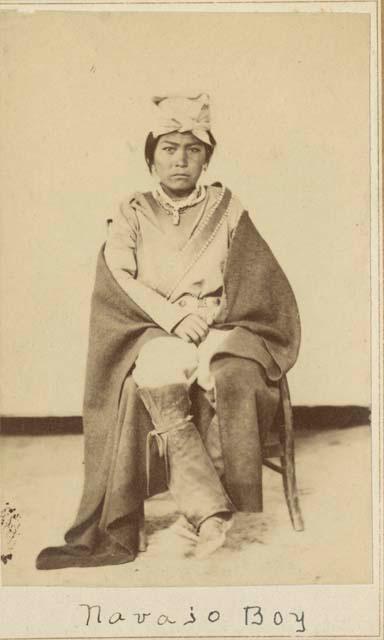 Portrait of a Navajo boy, seated about 13 years old