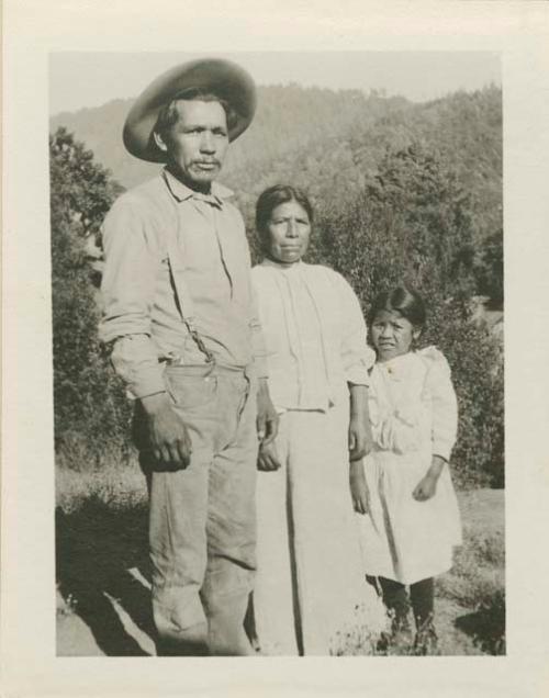 Theodore Billy, Mrs. Peters and a young girl stand for a photo