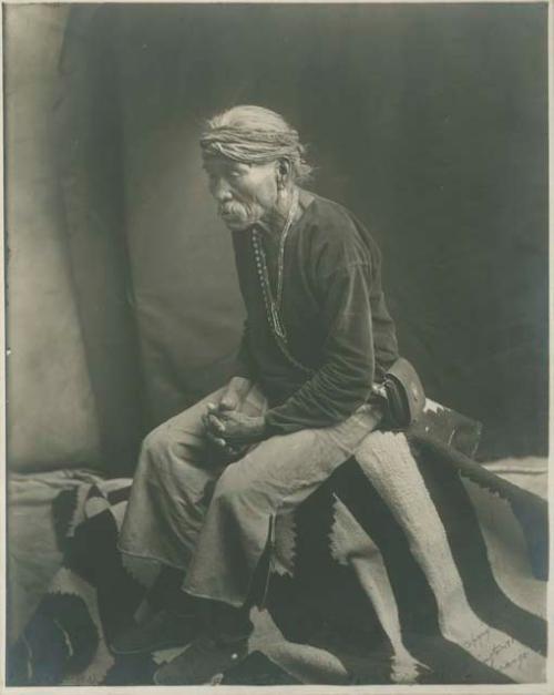 Studio portrait of an old Navajo Medicine Man "Thinking over the past"