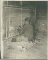 Navajo woman weaving on a loom