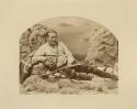 Reclining man with bow and arrows in a studio-staged scene