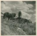 Covered wagon and people