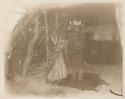 Navajo family standing inside a summer house