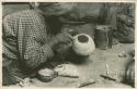 Navajo woman painting the bottom of a bowl
