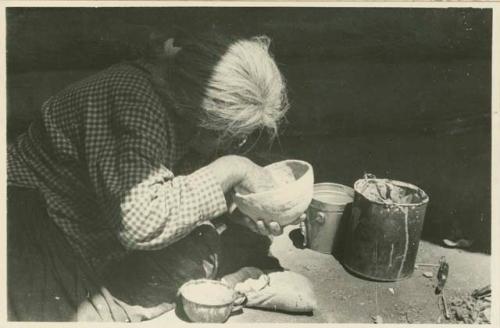 Navajo woman slipping the interior of a bowl