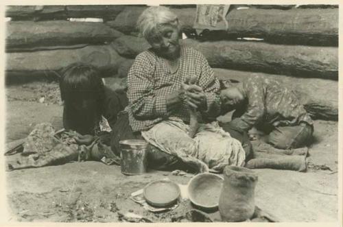 Navajo woman rolling a fillet of paste