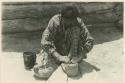 Navajo woman obliterating fillet juncture on a pot