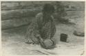 Navajo woman kneading the paste to make pottery