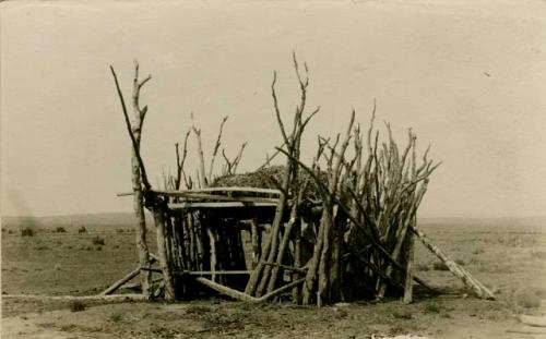 Corral belonging with hogan and corn oven