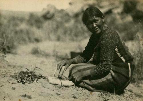 Woman pounding the roots of the Rhus aromatica to loosen the bark