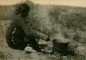 Woman boiling the root bark of the Rhus armonatica to obtain the red dye, "saystozzie-batoh"