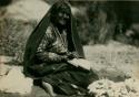 Woman carding and washing wool