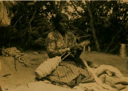 Woman coiling wool to be used for blanket making