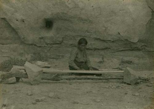 Woman placing warp on the loom