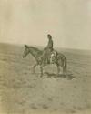 Navajo man on horseback