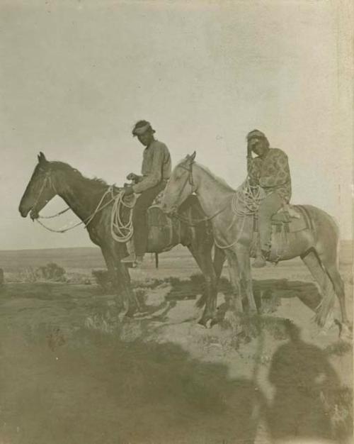 Two Navajo men on horseback