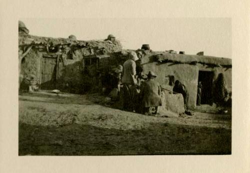 View of people outside pueblos at  Acoma