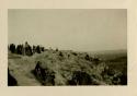 People standing on cliff at Acoma