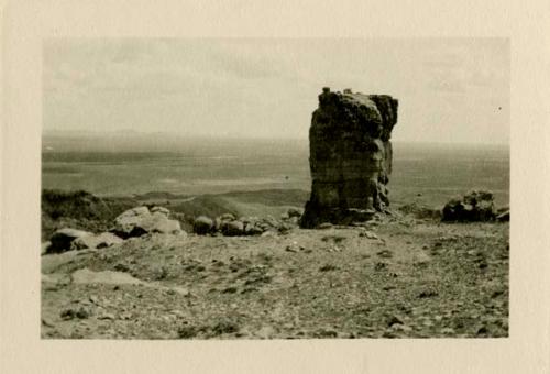 Overlooking cliff at Acoma. Large rock in foreground