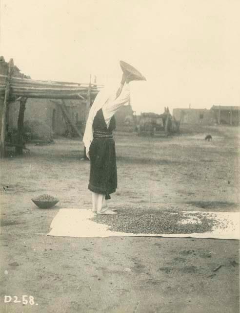 Woman sifting corn