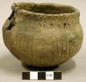 Ceramic complete vessel, incised design around body, impressed design around rim