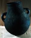 Black pot, handle on each side, incised decoration, circumference 31 5/8" wrappe