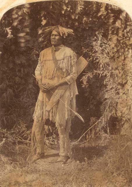 Tanoats standing with arrow in his hand