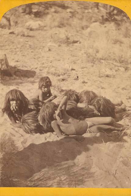 Group of children lying on ground