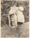 Ed. Somers' children-- a small girl standing alongside baby in a cradleboard