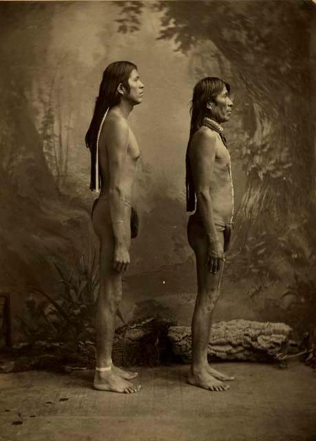 Full-length studio portrait of two men. Profile.