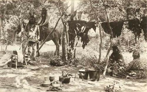 People seated around camp