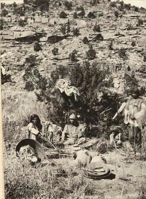 People seated around camp, Paiute