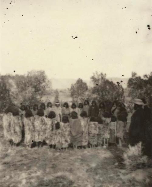 Circle of people, wearing blankets