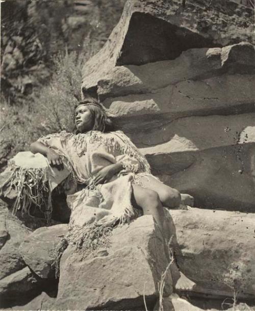 Woman seated on rocks