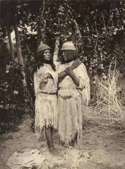 Two women with arms around one another