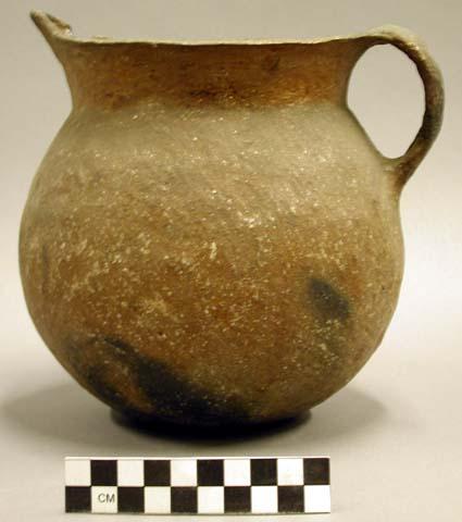 Large pitcher of dark brown ware