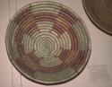 Basket tray, coiled. Made of bear grass (natural and dyed paint, orange).