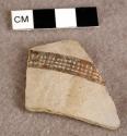 Sherd of pottery milk bowl