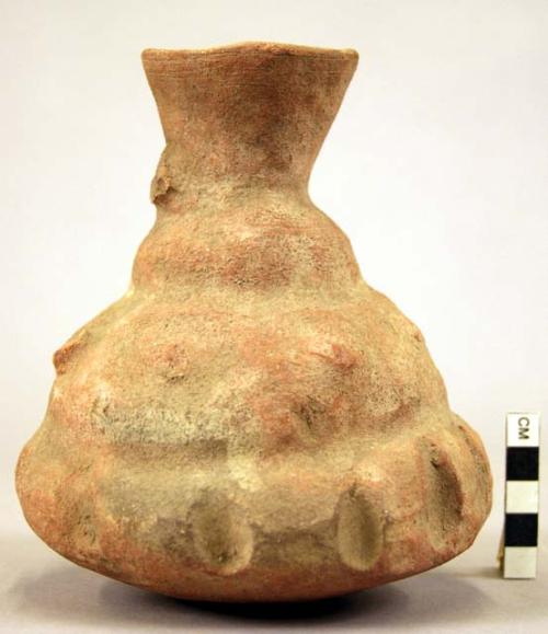 Pottery jar, handle on side, red, with notched and irregular surface