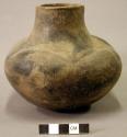 Ceramic vessel, short neck, cord impressed line around shoulder, flat base.