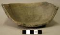 Ceramic partial vessel, missing sherds from body and rim, flat base, plain, crac