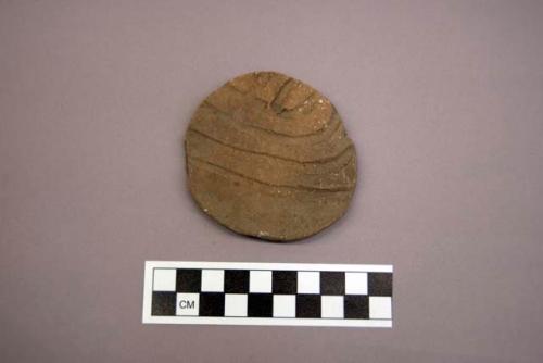 Ceramic, earthenware sherd, reworked into a disc, incised, possible Ramie design, shell-tempered