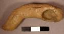 Zoomorphic figurine. animal head at one end & elongated neck with miniature dipp