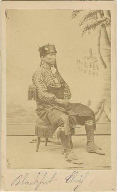 Studio portrait of seated chief