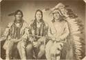 Three chiefs, seated in studio, one is wearing headdress