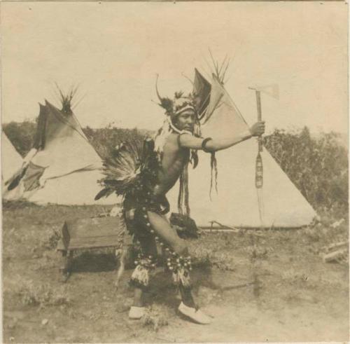 Man posing with axe and hip ornament