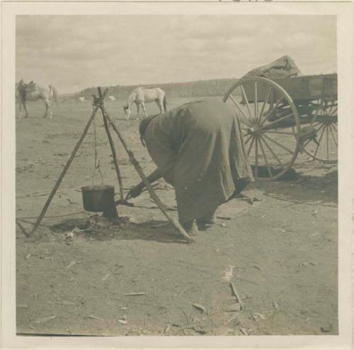 Crow Indian cooking over fire at Billings, MT where they came from their reservation to trade and dance